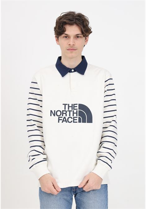 White men's polo shirt with blue print on the front and stripes on the sleeves THE NORTH FACE | NF0A8704SVO1SVO1